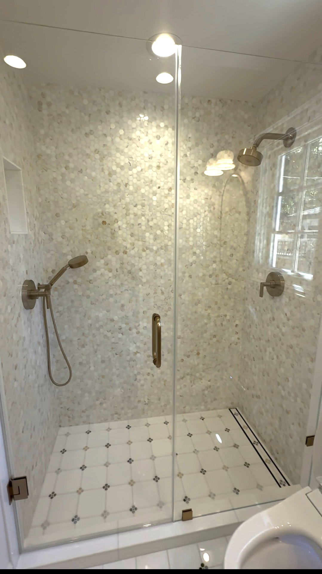Remodeled bathroom by JMF Builders in Santa Clara, CA with tiled shower and vanity